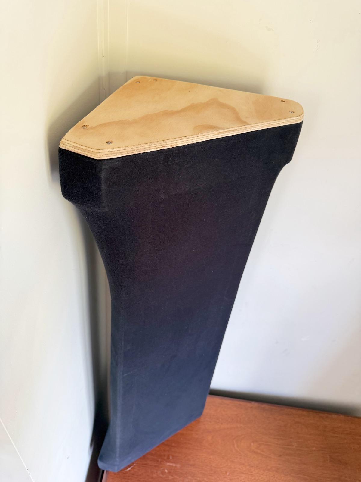 Unfinished corner bass trap positioned against a room wall to check fit before final wrap