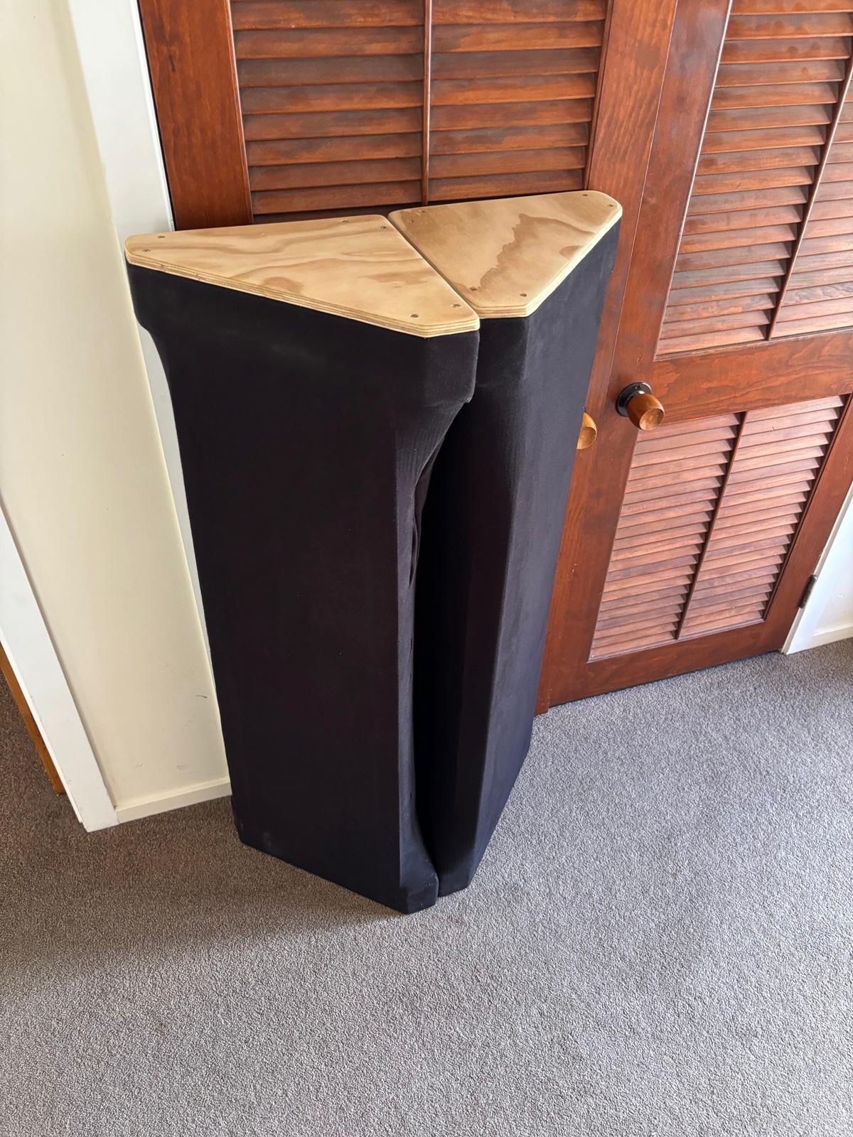 Corner bass trap with plywood top beside timber louvre doors