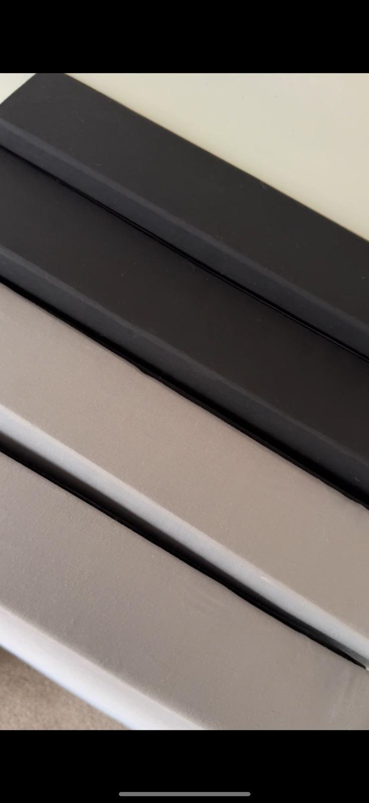 Close up of black, grey and white fabric-wrapped panel edges