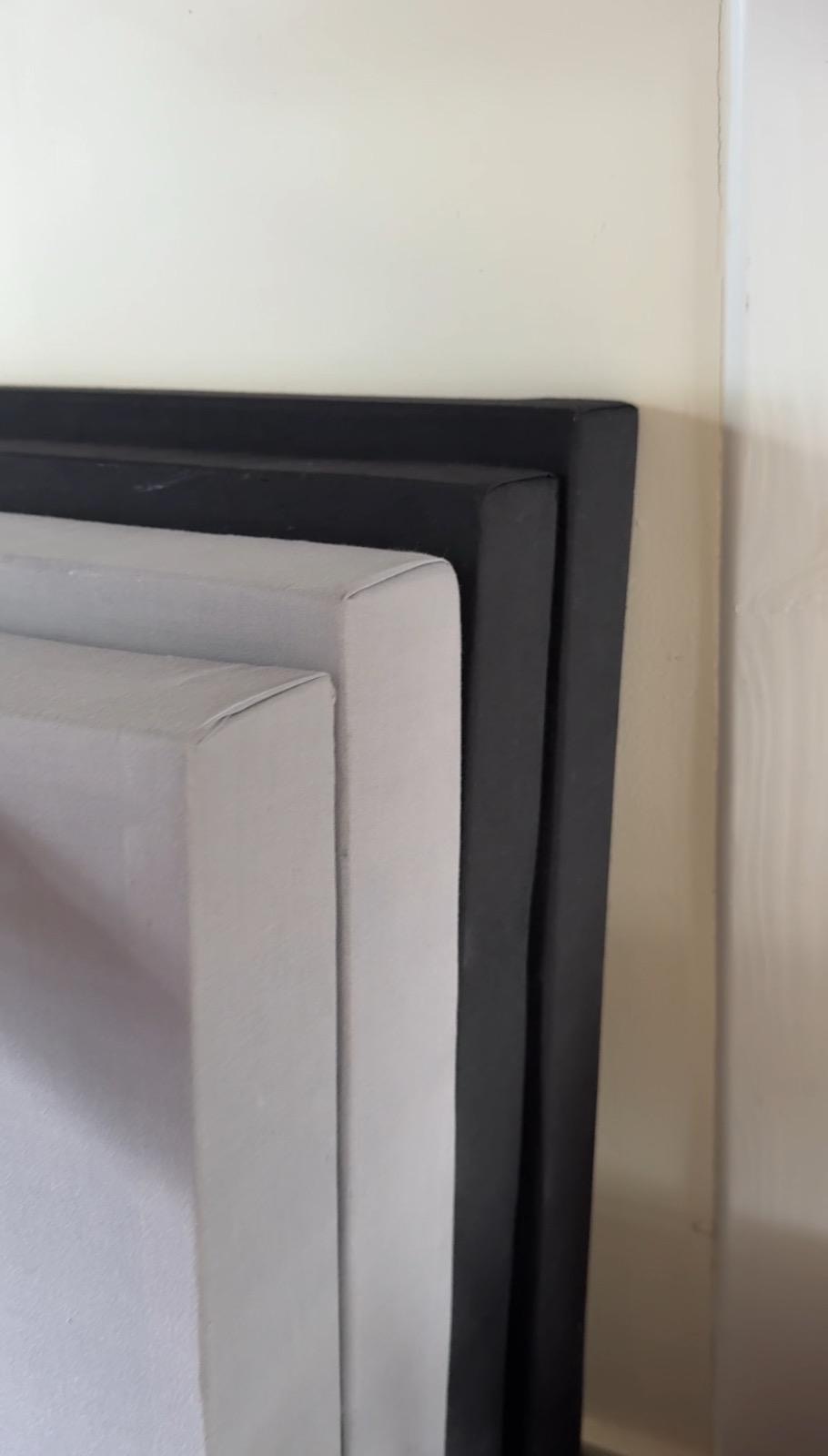 Close up detail of stacked black and grey fabric wrapped panel corners